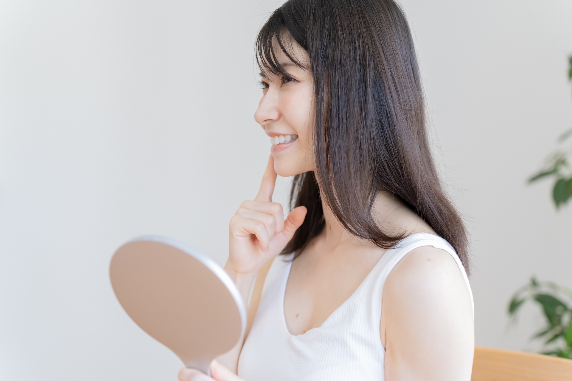 歯に指を当てる日本人女性